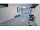 Well-lit three-car garage with epoxy flooring at 18835 W San Miguel Ave, Litchfield Park, AZ 85340