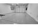 Clean three-car garage featuring epoxy flooring and ample space for vehicles at 18835 W San Miguel Ave, Litchfield Park, AZ 85340