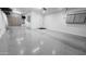 Spacious three-car garage with epoxy flooring and custom storage cabinets at 18835 W San Miguel Ave, Litchfield Park, AZ 85340