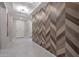 Hallway features elegant wood patterned wall and leads to a welcoming entrance, offering a stylish transition at 18835 W San Miguel Ave, Litchfield Park, AZ 85340