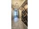 Inviting hallway with stylish light fixture and decorative wood accent wall at 18835 W San Miguel Ave, Litchfield Park, AZ 85340