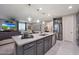 Open-concept kitchen island featuring granite countertops, stainless steel appliances, and bar seating at 18835 W San Miguel Ave, Litchfield Park, AZ 85340