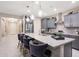 Stylish kitchen featuring granite countertops, stainless steel appliances, a breakfast bar, and pendant lighting at 18835 W San Miguel Ave, Litchfield Park, AZ 85340