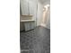 Laundry room featuring countertop space and custom tile flooring at 18835 W San Miguel Ave, Litchfield Park, AZ 85340
