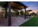 Outdoor kitchen with a bar, lighting, and grill, surrounded by mature landscaping at 18835 W San Miguel Ave, Litchfield Park, AZ 85340
