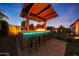 Outdoor kitchen featuring a bar, grill, and seating area, perfect for entertaining at 18835 W San Miguel Ave, Litchfield Park, AZ 85340