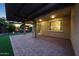 Spacious covered patio with views of the backyard, outdoor kitchen, and fire feature at 18835 W San Miguel Ave, Litchfield Park, AZ 85340