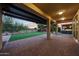 Expansive covered patio with brick, overlooking backyard and outdoor grilling area at 18835 W San Miguel Ave, Litchfield Park, AZ 85340