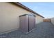 Practical storage shed located on a gravel side yard of the house at 18835 W San Miguel Ave, Litchfield Park, AZ 85340