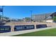 Outdoor volleyball court features sand, nets, and is surrounded by school buildings and banners at 18835 W San Miguel Ave, Litchfield Park, AZ 85340