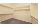 Spacious walk-in closet with carpet floor and built-in shelving for optimal organization at 18835 W San Miguel Ave, Litchfield Park, AZ 85340