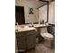 Cozy bathroom featuring a classic sink, toilet, decorative art, and patterned tile flooring at 2004 N 108Th Dr, Avondale, AZ 85392