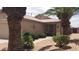 Beautiful front yard with lush green bushes and desert landscaping leading to a charming entry porch at 2004 N 108Th Dr, Avondale, AZ 85392