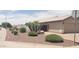 Side view of house, with desert landscaping and trees on a sunny day at 2004 N 108Th Dr, Avondale, AZ 85392