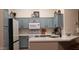 Modern kitchen with stainless steel appliances, and blue cabinets at 2004 N 108Th Dr, Avondale, AZ 85392
