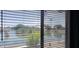 View of the lake through the blinds of the home at 2004 N 108Th Dr, Avondale, AZ 85392