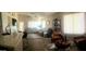 Open-concept living room showcasing a cozy seating area with large windows and ample natural light at 2004 N 108Th Dr, Avondale, AZ 85392