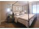 Primary bedroom with canopy bed, decorative pillows, and a cozy, welcoming atmosphere at 2004 N 108Th Dr, Avondale, AZ 85392