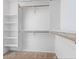Spacious walk-in closet with built-in shelves and rods for organized storage at 2004 N 108Th Dr, Avondale, AZ 85392