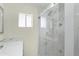Modern bathroom boasts marble shower, white vanity, and sleek fixtures for a spa-like experience at 211 N 7Th St, Avondale, AZ 85323