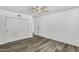 This bedroom features a ceiling fan, closet, and light gray flooring throughout at 211 N 7Th St, Avondale, AZ 85323