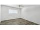 Cozy bedroom offers natural light from window, ceiling fan and light gray floors at 211 N 7Th St, Avondale, AZ 85323