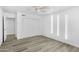 Bright bedroom offers ceiling fan, gray floors, storage closet and adjacent room access at 211 N 7Th St, Avondale, AZ 85323
