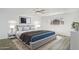 A staged bedroom features a large window, ceiling fan, and light gray flooring at 211 N 7Th St, Avondale, AZ 85323