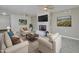 Comfortable living room showcasing a stone fireplace, ceiling fan, and neutral tones at 211 N 7Th St, Avondale, AZ 85323
