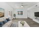 Bright living room features modern flooring, fresh paint, and double doors for natural light at 211 N 7Th St, Avondale, AZ 85323
