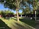 Spacious backyard with lush green grass and mature trees, perfect for outdoor activities and relaxation at 2201 N 29Th Pl, Phoenix, AZ 85008