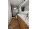 Stylish bathroom showcasing a double sink vanity with gold fixtures, sliding glass shower doors and a modern mirror at 2201 N 29Th Pl, Phoenix, AZ 85008