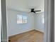 Bedroom featuring ample natural light, with wood-look floors and a modern ceiling fan at 2201 N 29Th Pl, Phoenix, AZ 85008