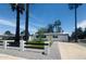 Charming home with solar panels and a beautifully landscaped front yard with palm trees at 2201 N 29Th Pl, Phoenix, AZ 85008