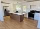 Open kitchen features modern cabinetry, stainless steel appliances and a large island at 2201 N 29Th Pl, Phoenix, AZ 85008