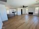 Bright living room with fireplace and sleek ceiling fan flowing seamlessly into a modern, well-equipped kitchen at 2201 N 29Th Pl, Phoenix, AZ 85008