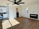 Bright living room with modern ceiling fan, fireplace, and view of the kitchen and bathroom at 2201 N 29Th Pl, Phoenix, AZ 85008