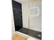 Beautiful shower showcasing black and white tile, gold trim and fixtures and a clear glass door at 2201 N 29Th Pl, Phoenix, AZ 85008
