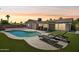 Backyard oasis at dusk featuring pool, lounge chairs, patio, and artificial turf at 2519 E Geneva Dr, Tempe, AZ 85282