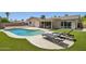 Backyard oasis featuring pool, lounge chairs, patio, and artificial turf at 2519 E Geneva Dr, Tempe, AZ 85282