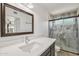 Modern bathroom with a walk-in shower, white countertops, and elegant fixtures at 2519 E Geneva Dr, Tempe, AZ 85282