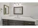 Bathroom featuring white countertops, decorative mirrors, and classic fixtures at 2519 E Geneva Dr, Tempe, AZ 85282