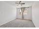 Bright bedroom with window, ceiling fan, and soft carpet for comfortable living at 2519 E Geneva Dr, Tempe, AZ 85282