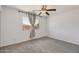 A bedroom with a window, tan drapes, neutral carpet, and a ceiling fan at 2519 E Geneva Dr, Tempe, AZ 85282