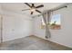 Bedroom with a window, tan drapes, neutral carpet, closet with sliding doors, and a ceiling fan at 2519 E Geneva Dr, Tempe, AZ 85282