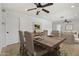 Open-concept dining room adjacent to the living room and kitchen featuring a wood table with six upholstered chairs at 2519 E Geneva Dr, Tempe, AZ 85282