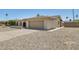 View of the house from the driveway showing the side entrance and gravel yard at 2519 E Geneva Dr, Tempe, AZ 85282
