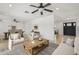 Open-concept living room with ceiling fans and ample seating, perfect for entertaining at 2519 E Geneva Dr, Tempe, AZ 85282