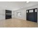 Bright living room with a brick fireplace, built-in shelving, and neutral tile floors at 2519 E Geneva Dr, Tempe, AZ 85282