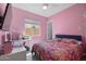Cheerful bedroom with a colorful comforter, ceiling fan, and a dedicated desk area at 2750 W Pollack St, Phoenix, AZ 85041